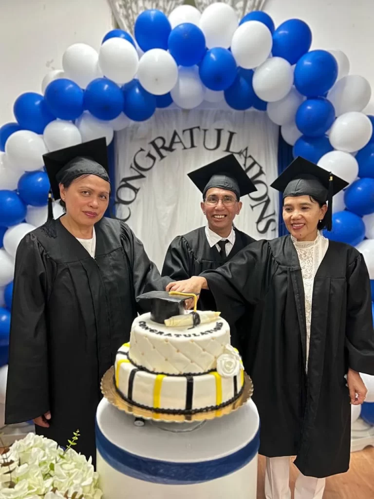 Pastor Melinda, Romulo and Jovette cutting their graduation cake