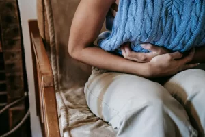 A woman having stomach cramp due to PCOS